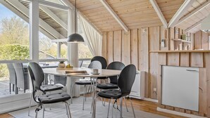A dining area with a round table, six chairs, and a pendant light. - Beautiful home in Sydals with kitchen (Sydals)