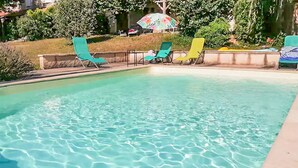 A clear swimming pool with several lounge chairs and an umbrella. - Gorgeous home in Sauzet with swimming pool (Sauzet)
