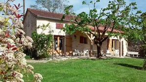 A rustic house with a tiled roof, a small garden, and outdoor furniture. - Gorgeous home in Sauzet with swimming pool (Sauzet)