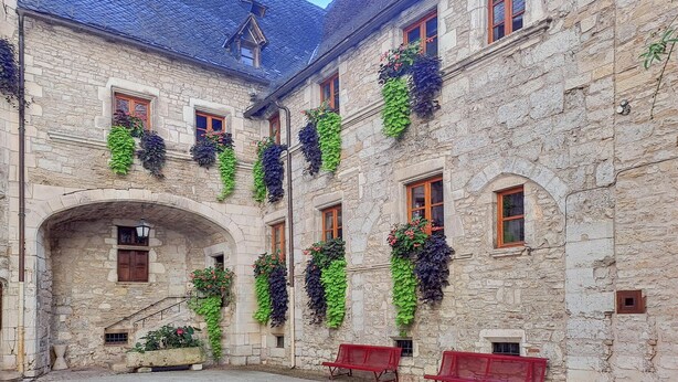 A stone building with arched windows and a courtyard. - Gorgeous home in Sauzet with swimming pool (Sauzet)