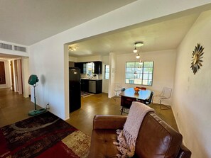 Relax in this stylish living area with a comfortable sofa, dining table for four, and a well-equipped kitchen.