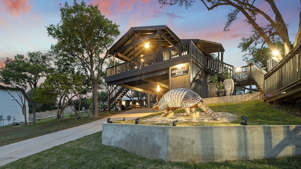 A wooden multi-level building with a large turtle sculpture in the foreground.