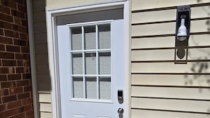 A white front door with a window, a mailbox, and a welcome mat. - Deluxe! New Apt Loft Near Downtown – Ready for Families and Business Travelers. (Raleigh)