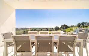 A terrace with outdoor seating and a view of the countryside. - Gorgeous apartment in Estepona with swimming pool (Estepona)