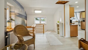 A modern living room with a large window, a dining area, and a kitchen. - Lovely apartment in Malchow with WiFi (Malchow)