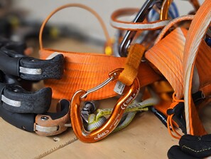A close-up of a climbing harness with metal carabiners and straps. - Holiday Home '4061 Maison Gerard Roccia Viva' (Cogne)