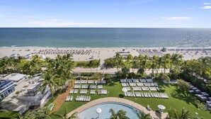 A resort with a pool, beach, and palm trees. - Direct Ocean View Studio at Sorrento Fontainebleau, Miami Beach (Miami Beach)