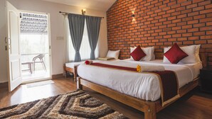 Een slaapkamer met een bakstenen muur, een houten bed, wit beddengoed en een rode plaid.