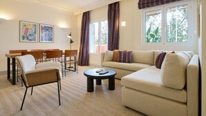 A modern living room with a sofa, chairs, a coffee table, and artwork on the walls. - Adriano 2.2 by Home at Homes (Sevilla)