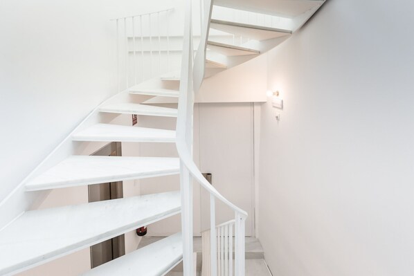 A white spiral staircase in a modern interior.