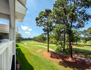 A golf course with a clear view of the fairway, sand bunkers, and a well-maintained green.