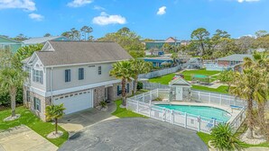 A residential property with a swimming pool, a fenced yard, and a garage. - 2185 Sanibel Court (Myrtle Beach)