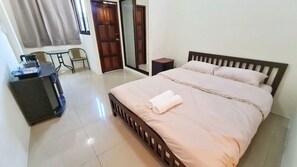 Un dormitorio con cama, escritorio, silla y armario.