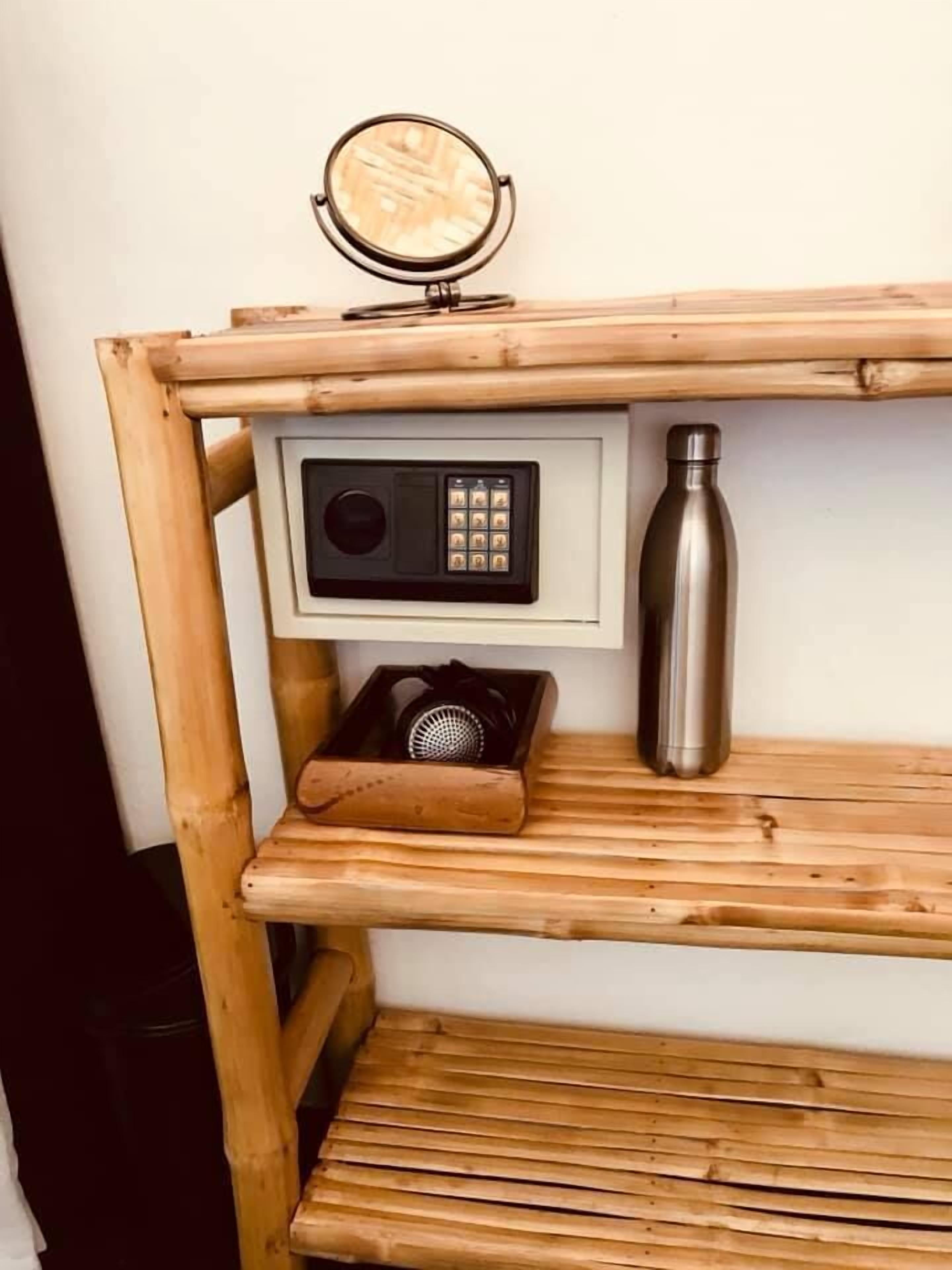 A wooden shelf with a radio, a water bottle, and a speaker.