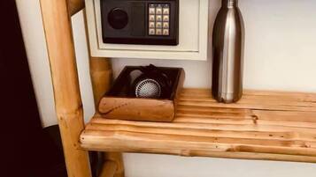 A wooden shelf with a radio, a water bottle, and a speaker.