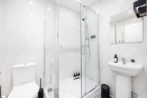 Shower, hair dryer, towels, shampoo