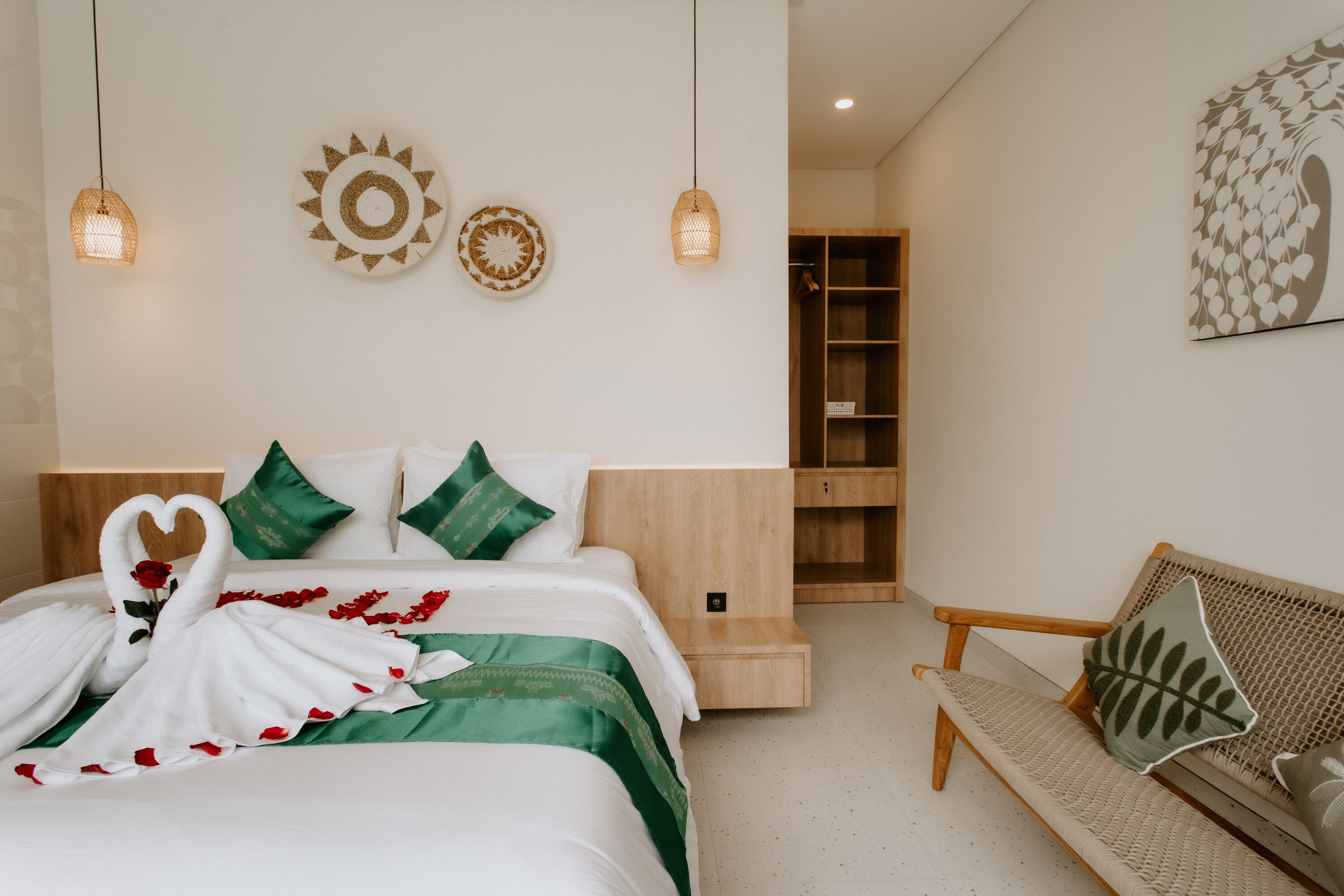 A modern bedroom with a bed, bedside table, and a wooden bench.