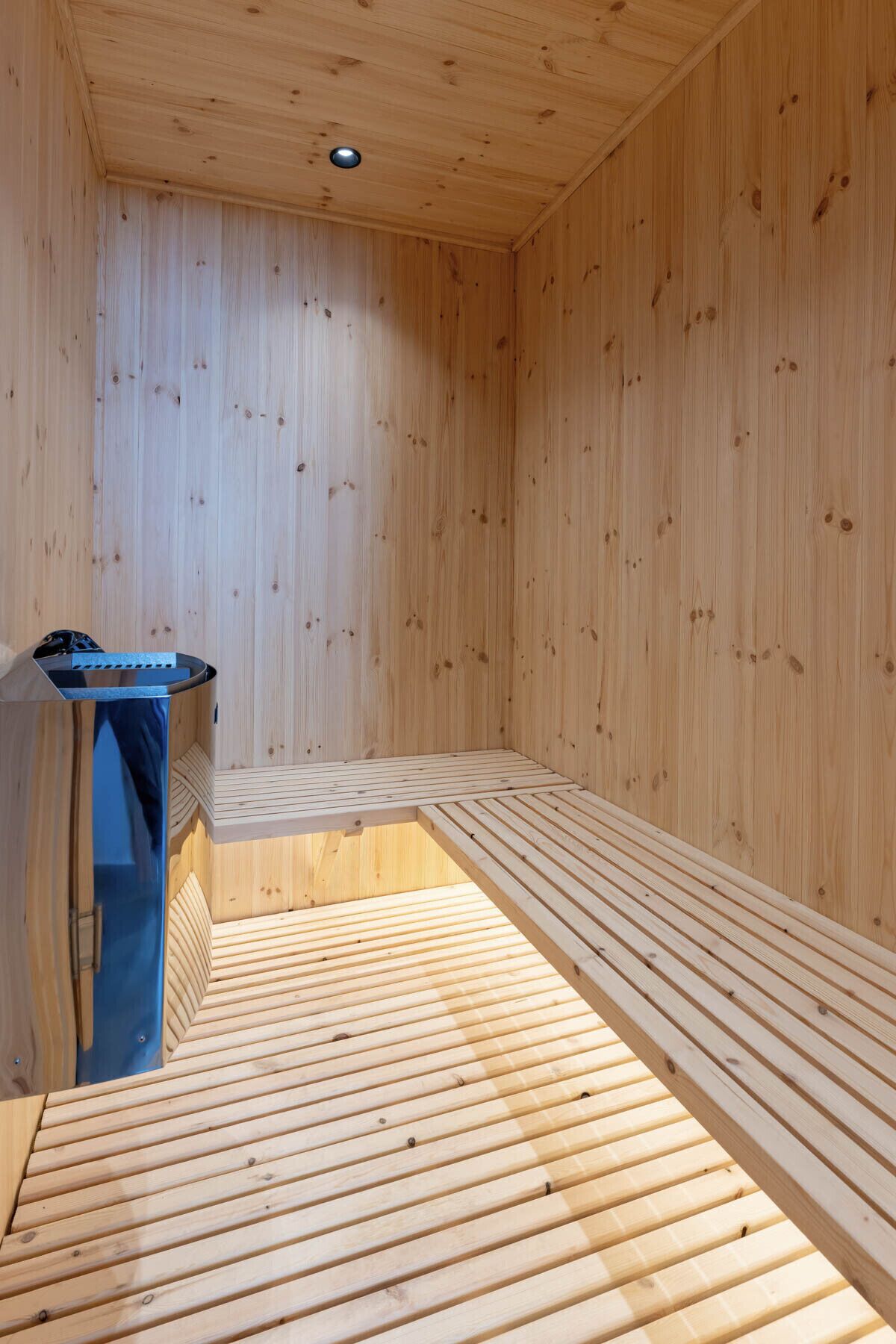 A sauna room with wooden walls and benches.