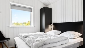 A bedroom with a bed, a window, a chair, and a wardrobe. - Pet friendly home in Sydals with WiFi (Sydals)
