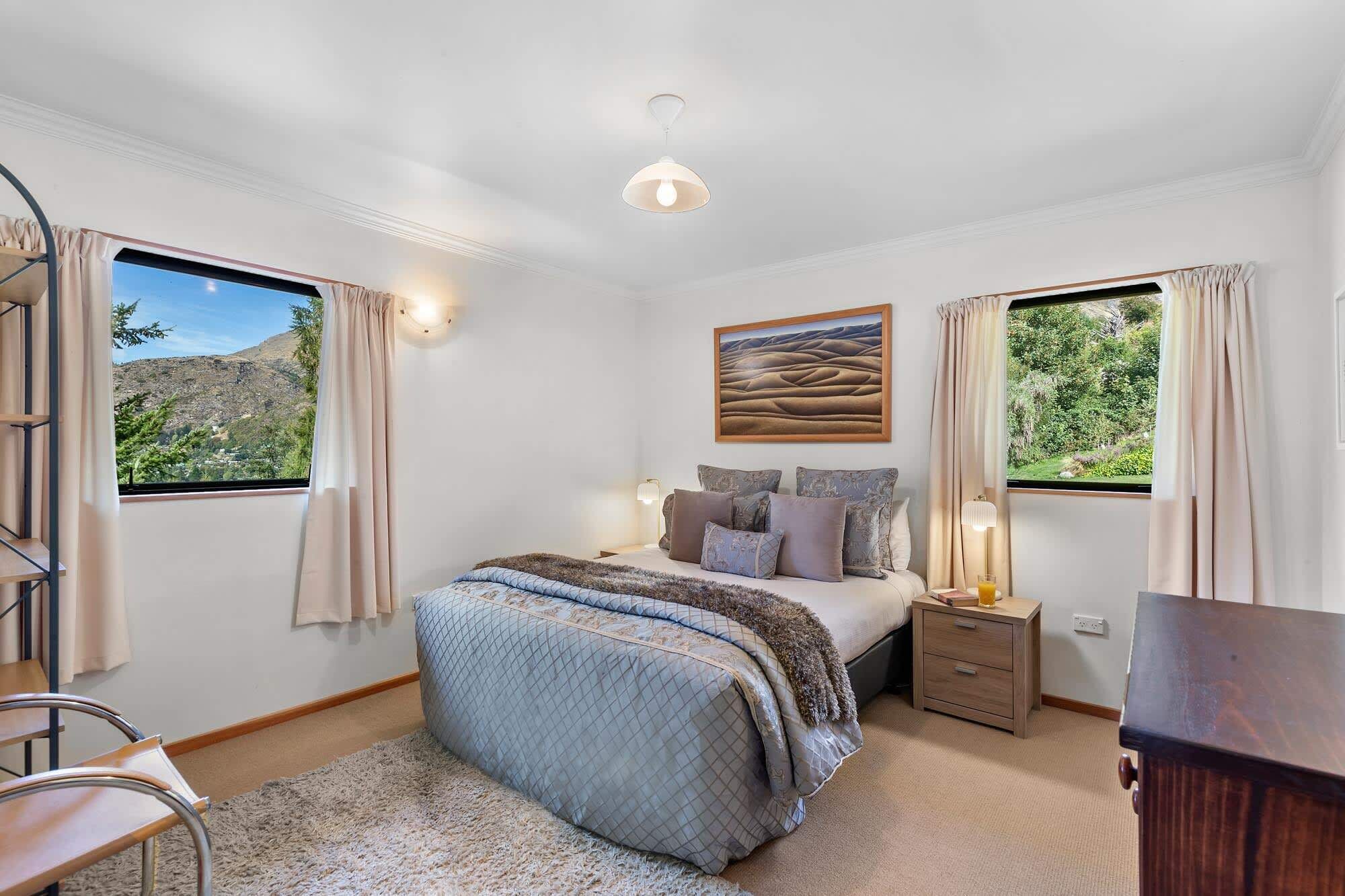 Bedroom Retreat: Stunning views and plush decor create the perfect escape in Queenstown!