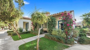 A residential property with a well-maintained lawn, a patio, and a garden with flowering plants. - Luxury Resort Villa w/Pool, Hot Tubs & Views (La Quinta)