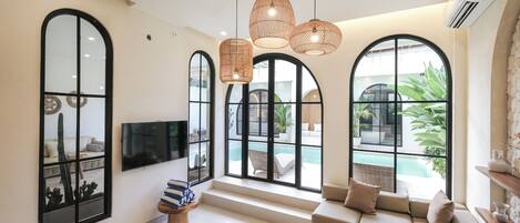 Villa, 3 Bedrooms, Pool View | Living room | 50-inch TV with cable channels