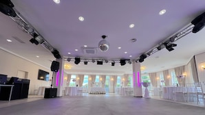 A spacious hall with a stage, tables, and chairs arranged for an event. - La Melis  (Geldern)