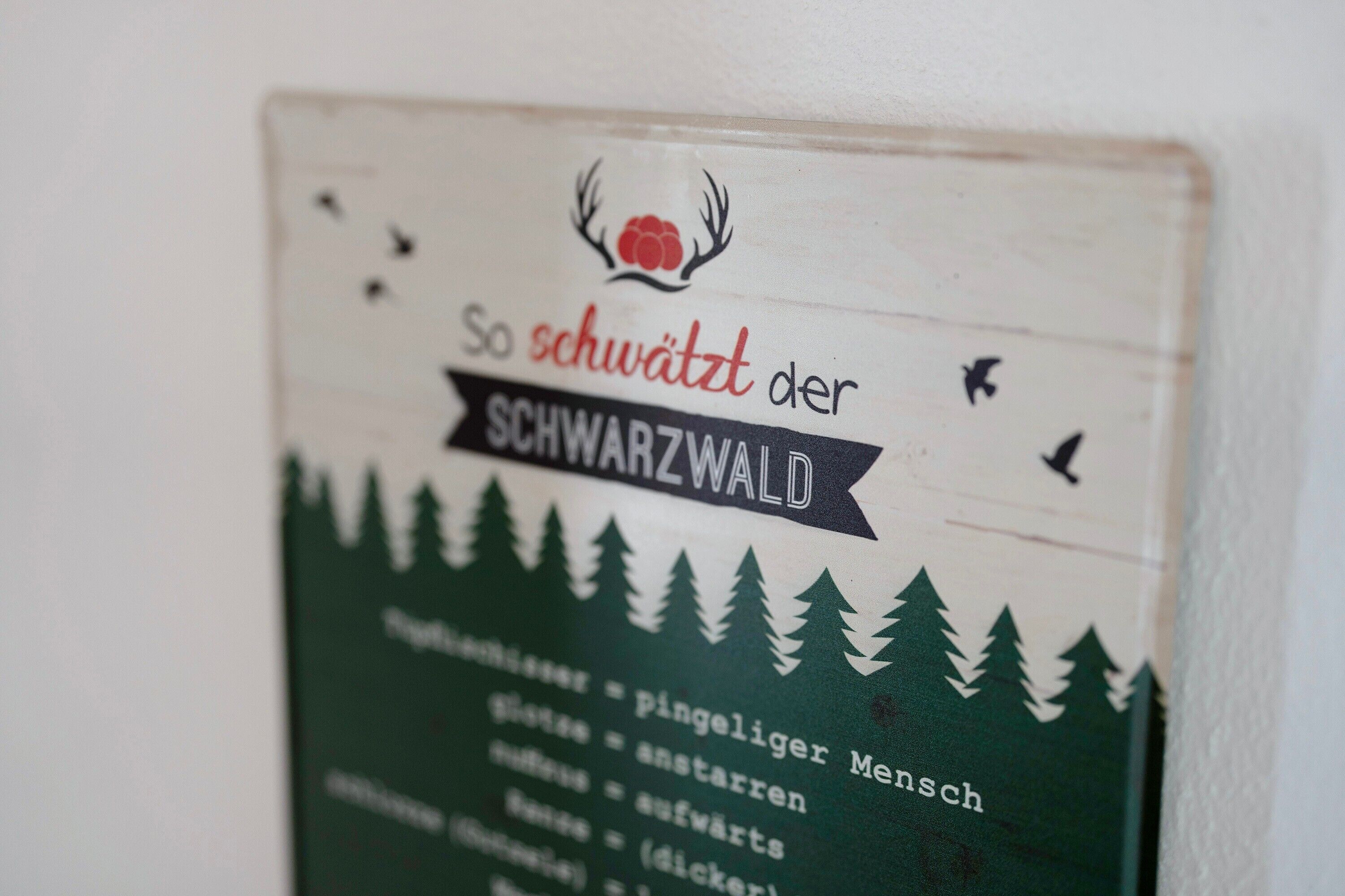 A sign with text and a logo, likely indicating a location or establishment.