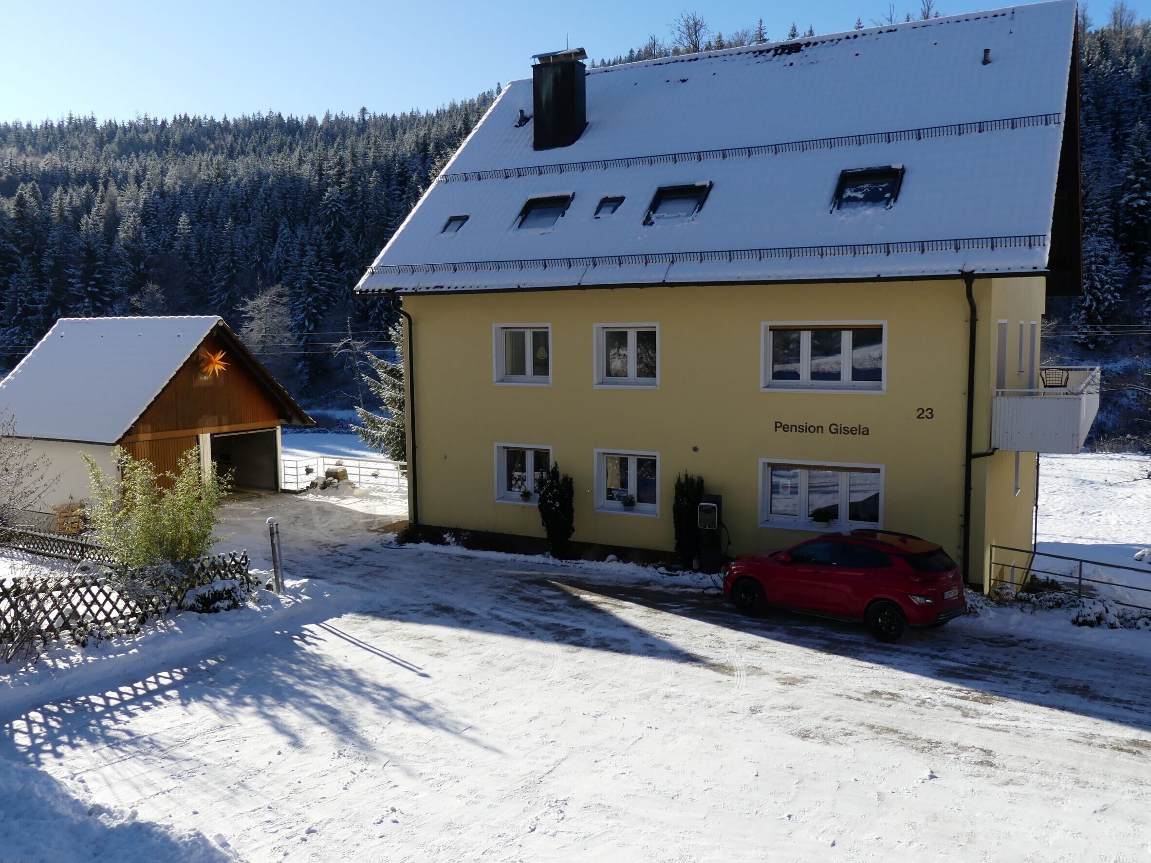 A yellow building with the name 'Pension Gisela' and the number 23.