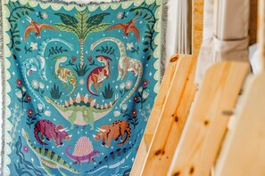 A colorful tapestry with prehistoric creatures and plants.