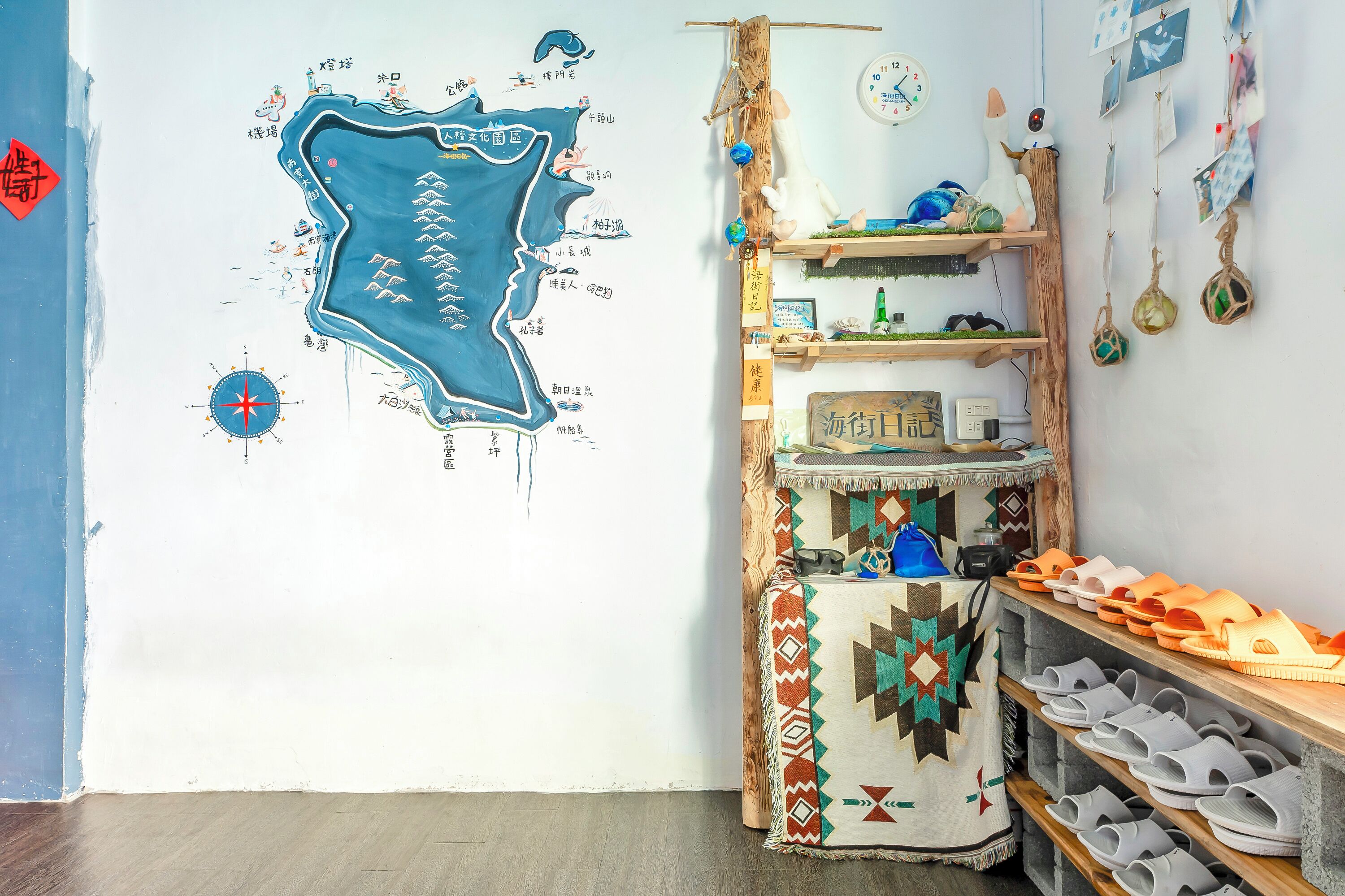A room with a wall map, shelves with shoes, and a small table with a sign.