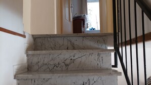 A marble staircase with a handrail, leading to a room with a window and a door. - Vacation home in Tuscany park of Apuane near spa. Five Lands and Versilia (Monzone)