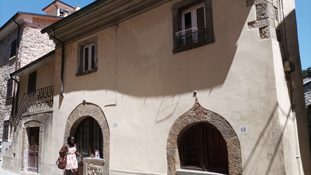A building with arched doorways and windows, numbered 49 and 69. - Vacation home in Tuscany park of Apuane near spa. Five Lands and Versilia (Monzone)
