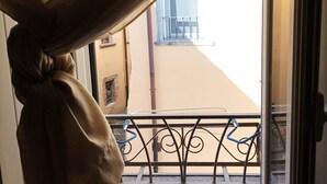 A balcony with a metal railing and a view of a building across the street. - Vacation home in Tuscany park of Apuane near spa. Five Lands and Versilia (Monzone)