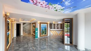 A spacious lobby with a polished marble floor, a staircase, and a mural of cherry blossoms on the ceiling. - Citrus Luna Suite (Konyaalti)