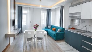 A modern kitchen with white cabinets, a marble backsplash, and a built-in oven. - Citrus Luna Suite (Konyaalti)