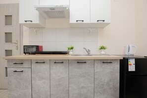 Studio, Balcony | Private kitchen | Oven, coffee/tea maker, electric kettle, cookware/dishes/utensils - Gagarina Studio With Balcony by Renters (Warsaw)