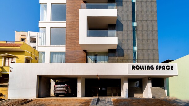 A modern building with a flat roof, multiple balconies, and a sign reading "ROLLING SPACE". - Rolling space (Puducherry)