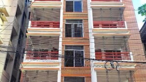 A multi-story building with a sign for White Rose Suites Ltd. and a hotel sign. - White Rose Suites Ltd (Dhaka)
