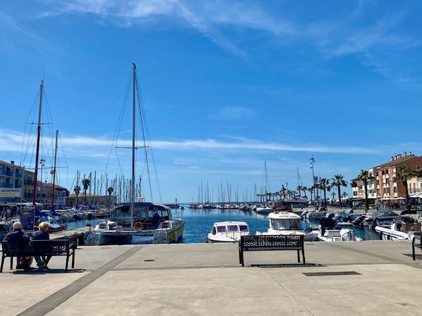 Enjoy waterfront views from the marina's benches, surrounded by docked boats.