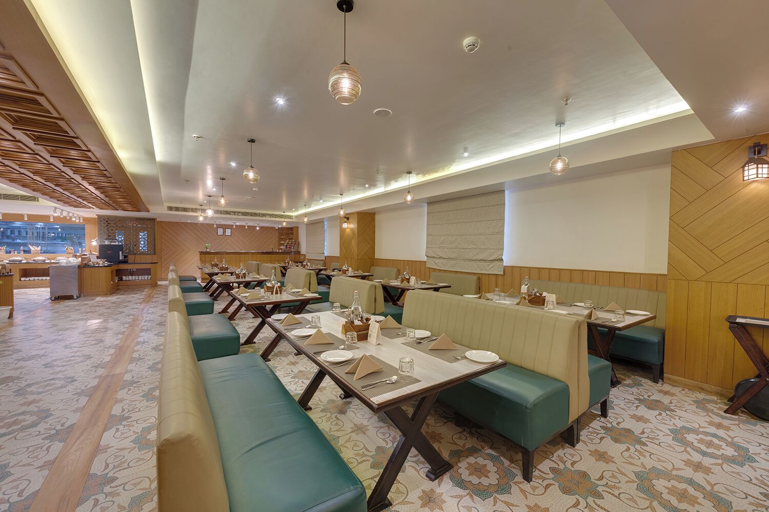 A restaurant with booths, tables, and a buffet area.