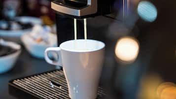 A coffee machine dispensing coffee into a cup.