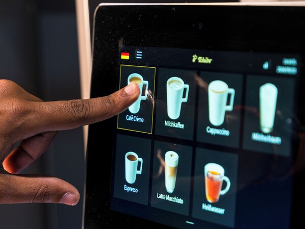 A tablet displaying a menu of coffee and tea options. - JustStay München Hotel & Apartments (Vaterstetten)