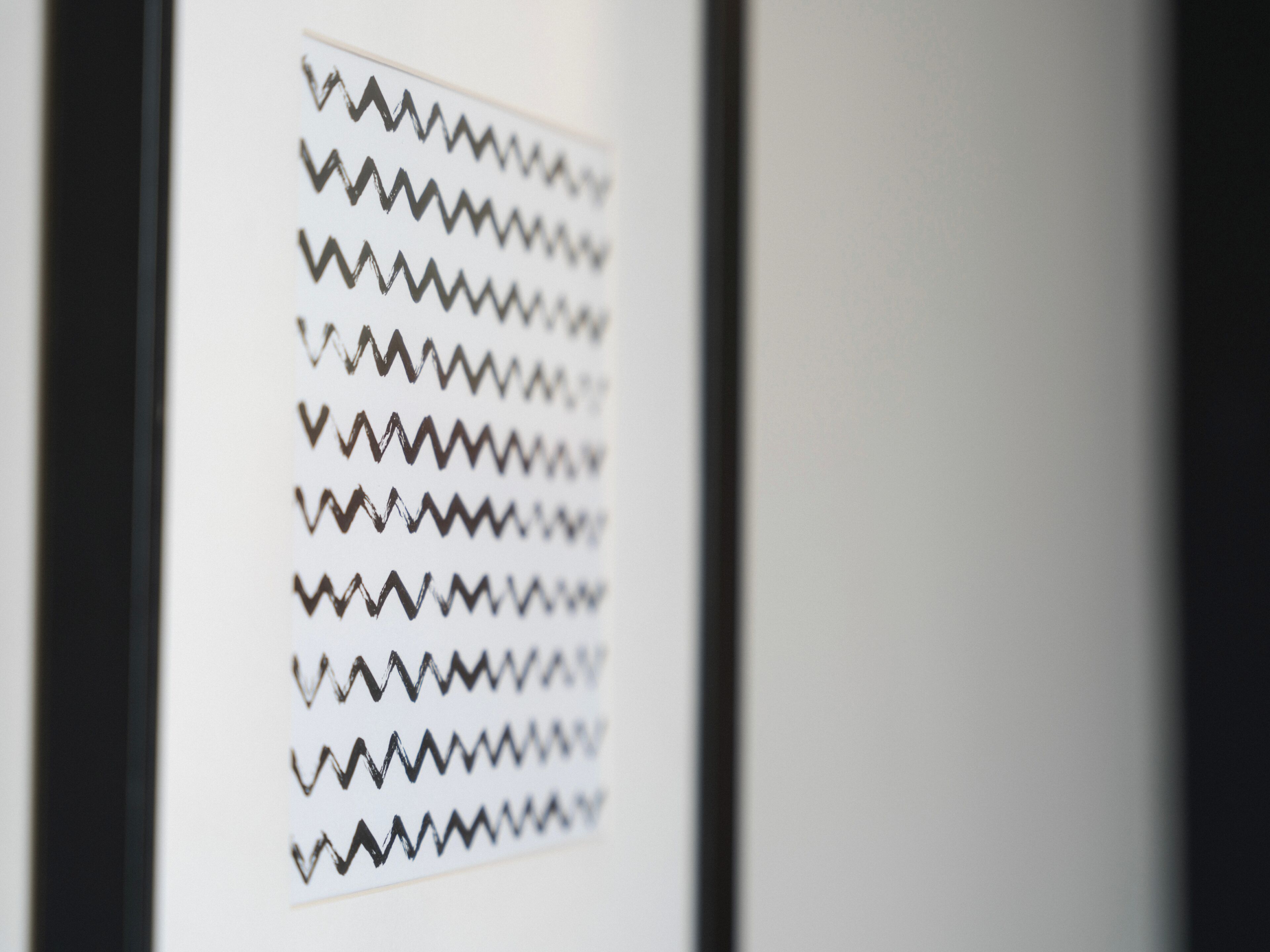 A close-up of a patterned wall with zigzag lines.