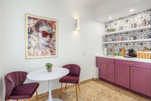 A kitchen with a white countertop, purple cabinets, and a tiled backsplash. - Brigitte Suite · Dog-Friendly Yard, Palm Springs (Palm Springs)