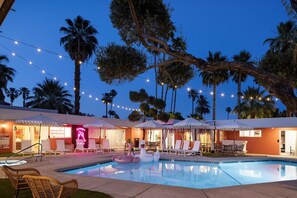 A pool area with lounge chairs, umbrellas, and a neon sign. - Audrey Suite · Dog yard + pool, 3 min to downtown (Palm Springs)