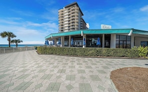 A beachfront hotel with a modern design, featuring a prominent building with balconies and a sign reading "Oceans".
