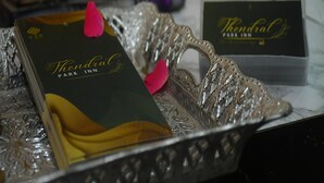 Een dienblad met een voorwerp met het logo van 'Thandral Park Inn' en een 'Thandral' kaart.