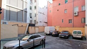 A narrow urban street with parked cars and a building with a red facade. - Madrid - Studio BB Sol/gran Via (Madrid)