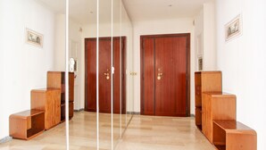 A hallway with wooden doors and built-in shelving units. - Large & Quiet Home in Rome Monteverde (Roma)